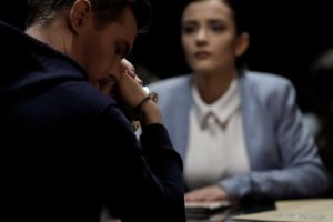 Man in handcuffs talking to woman