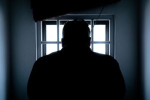 man in jail cell