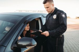 Police officer talking to woman in car